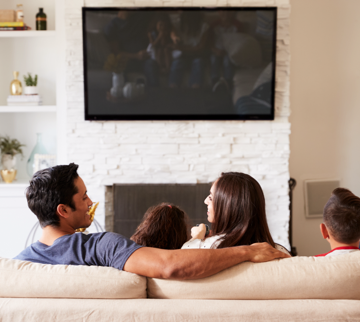 family watching tv mounted on wall